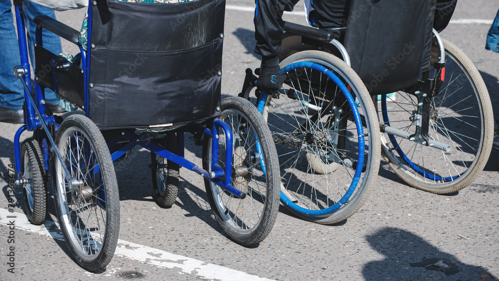 Fototapeta premium wheelchair wheels closeup on asphalt