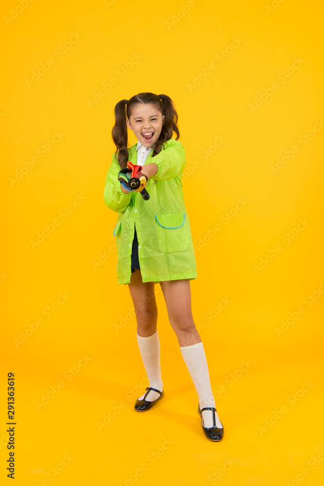 Always prepared for the unexpected. Small kid with happy look. Little girl with autumn look on yellow background. Cute child having elegant look in raincoat with umbrella. Comfort and school look Always prepared for the unexpected. Small kid with happy look. Little girl with autumn look on yellow background. Cute child having elegant look in raincoat with umbrella. Comfort and school look