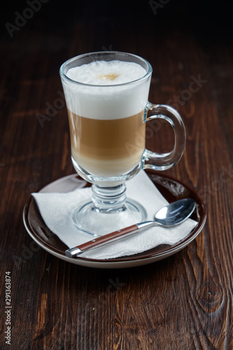 Cappuccino on a brown wooden background. Menu