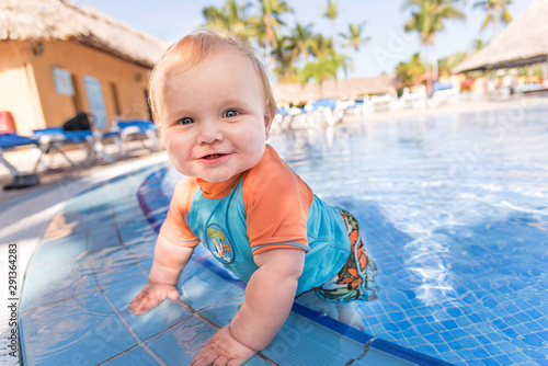 little boy standing in swimming pool