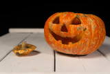 Halloween pumpkin on a wooden table on a background of white boards. Halloween background.