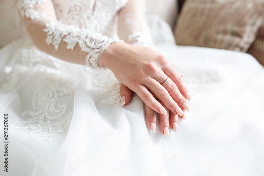 women's hands folded on their knees in anticipation of the wedding and the groom women's hands folded on their knees in anticipation of the wedding and the groom