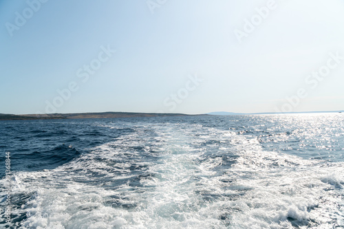 Wave traces on the blue ocean surface with copy space