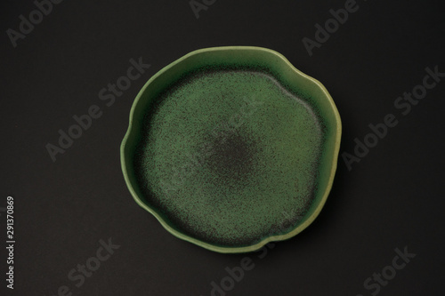 ceramic dishes: plates and gravy boats on a black background