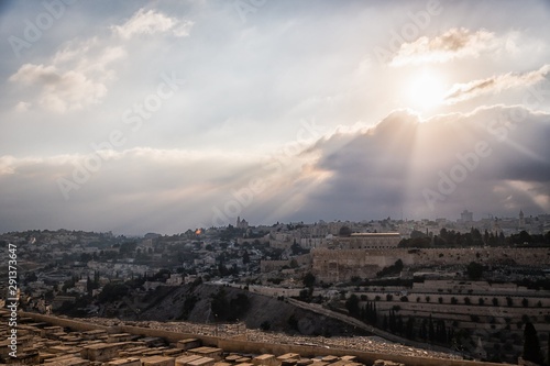 Beautiful sunset view of Jerusalem Old City from the Mount of Olives. Sky with sun rays