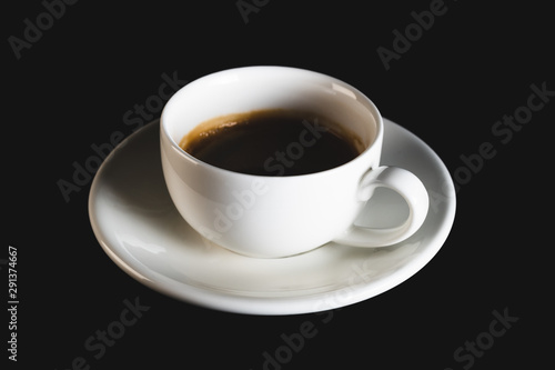 White espresso cup with black coffee on black background. Coffee cup rear view