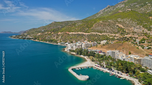 Aerial drone photo of famous seaside area and main town of Loutraki with sandy organised beach with turquoise clear sea and resorts, Greece © aerial-drone