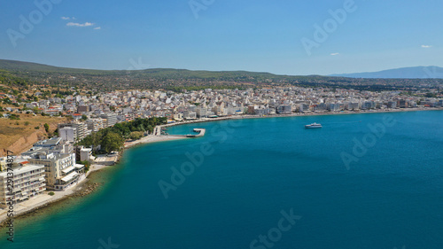 Aerial drone photo of famous seaside area and main town of Loutraki with sandy organised beach with turquoise clear sea and resorts, Greece © aerial-drone