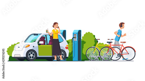Woman charging electric car at recharging power station