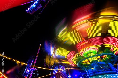 Photography Abstract colorful funfair carosuell in neon colors in motion at a fun fair