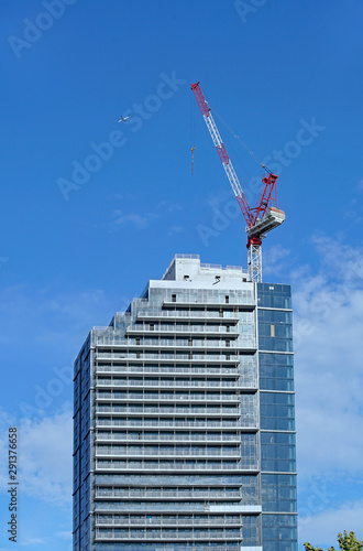 construction of highrise apartment building with crane on top