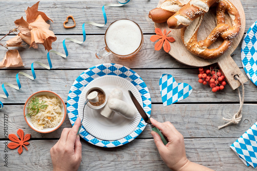 Oktoberfest traditional food and beer, flat lay on wooden table photo