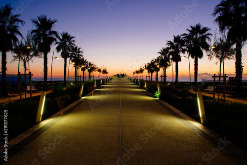 Fototapeta Naklejka Na Ścianę i Meble -  Breathtaking sunset in the coastline of tuscany, with the lido di camaiore new modern pier, Italy