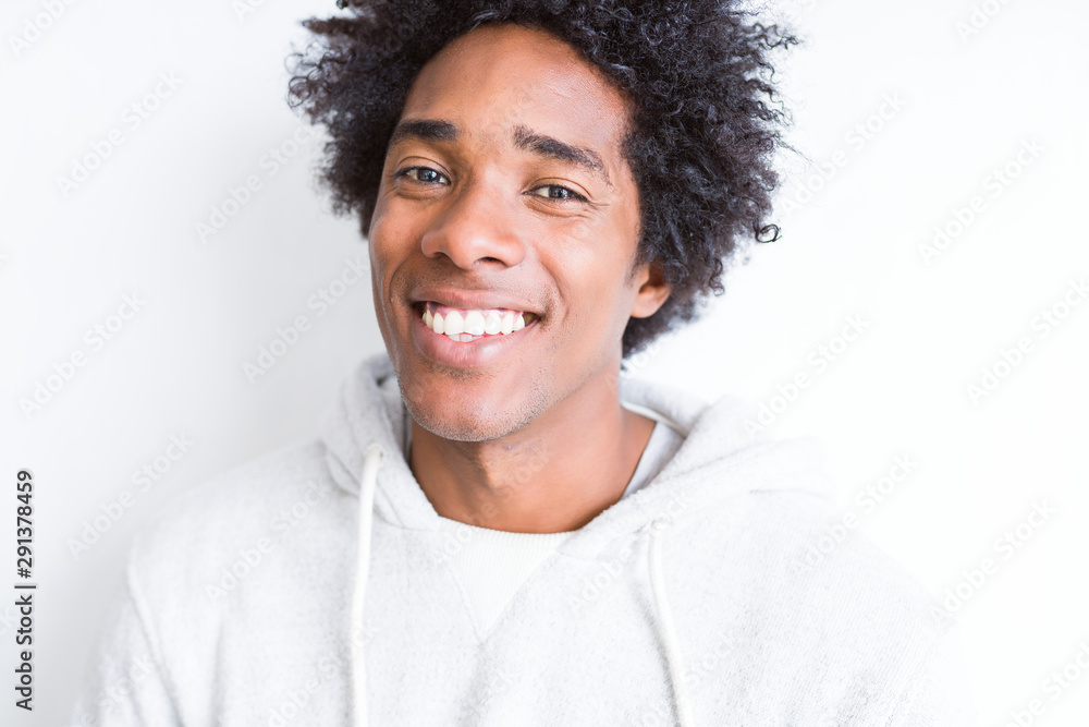 Handsome african american man with afro hair over white background with a happy and cool smile on face. Lucky person. Handsome african american man with afro hair over white background with a happy and cool smile on face. Lucky person.