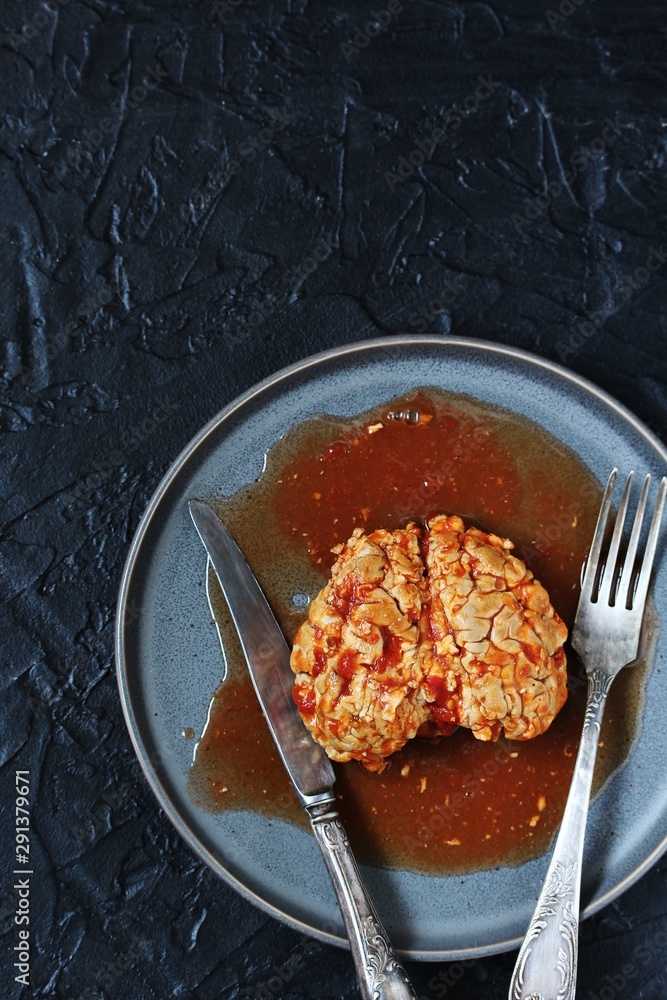 spooky halloween food. brains of a cow, sheep or calf in tomato sauce