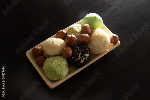 keto protein balls and matcha tea balls recipes on dark wooden background . it works ketogenic diet. photo