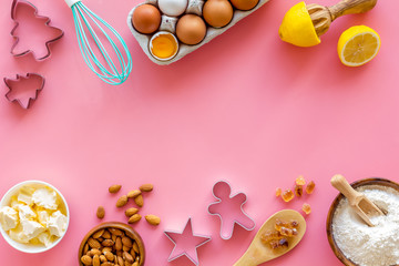 Cooking for Christmas or New Year dinner. Baking background. Dough ingredients on pink background top view copy space