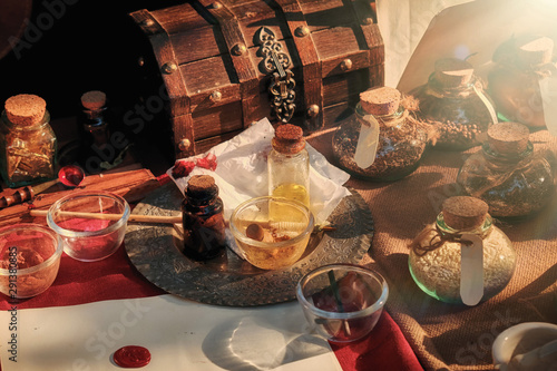Magical ingredients for making witch potions for Halloween. Real magic bottles, flasks and wooden chest