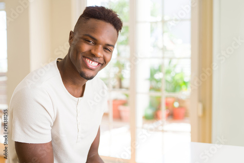 Handsome african young man smiling cheerful with a big smile on face