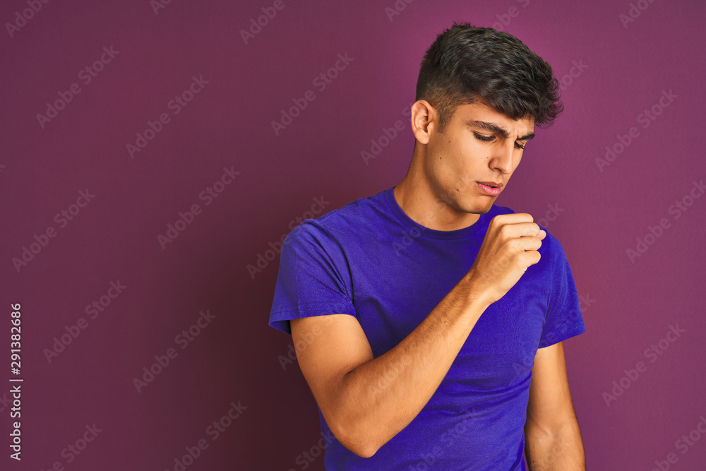 Young indian man wearing t-shirt standing over isolated purple background feeling unwell and coughing as symptom for cold or bronchitis. Healthcare concept. Young indian man wearing t-shirt standing over isolated purple background feeling unwell and coughing as symptom for cold or bronchitis. Healthcare concept.