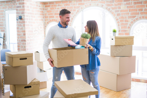 Young beautiful couple moving cardboard boxes at new home © Krakenimages.com