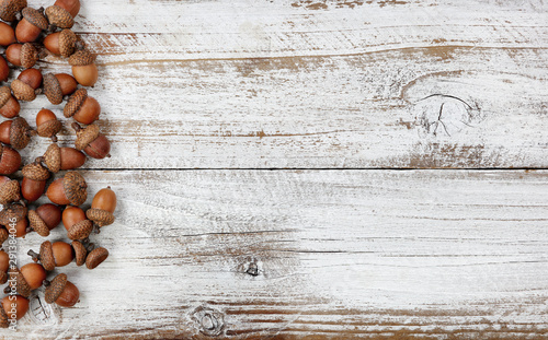 Autumn decorations with real acorns on white rustic wooden boards for Halloween or Thanksgiving