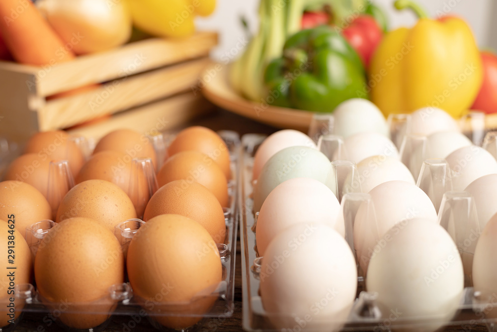 eggs of duck and chicken are placed on a wooden table with various vegetables eggs of duck and chicken are placed on a wooden table with various vegetables
