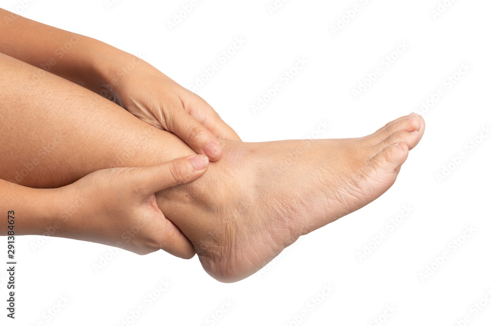 Woman with ankle pain using two hands holding leg and massaging painful her on isolated