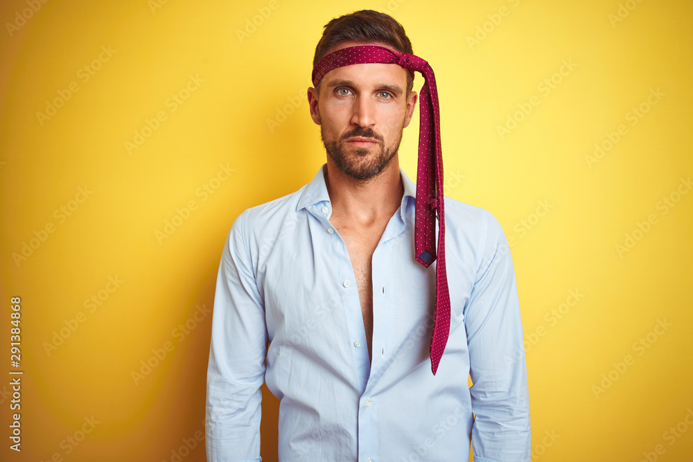 Hangover business man drunk and crazy for hangover wearing tie on head with serious expression on face. Simple and natural looking at the camera. Hangover business man drunk and crazy for hangover wearing tie on head with serious expression on face. Simple and natural looking at the camera.