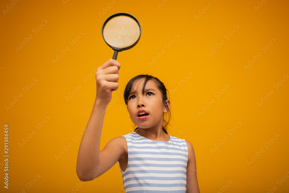 Portrait of happy little Asian child with magnifying glass. Portrait of happy little Asian child with magnifying glass.