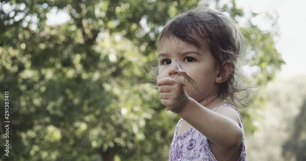 Cute baby girl exploring a park in late summer. Shot in 4K RAW on a cinema camera. Cute baby girl exploring a park in late summer. Shot in 4K RAW on a cinema camera.