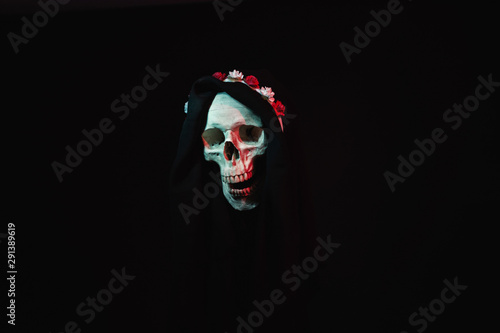 Death wearing a crown of flowers and a black robe