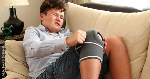 Painful child with protective knee brace photo