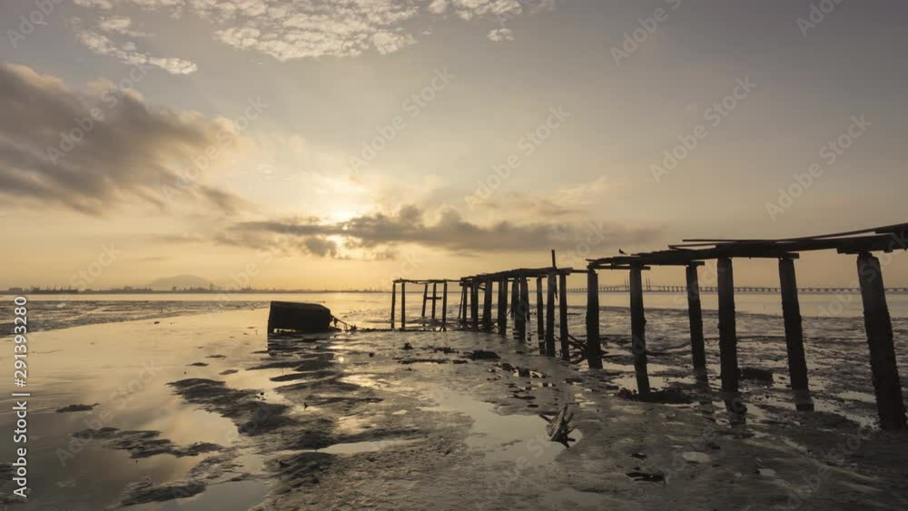 Timelapse low tide with sun ray breakthrough the cloud at the broken bridge with Penang Bridge as background. Timelapse low tide with sun ray breakthrough the cloud at the broken bridge with Penang Bridge as background.
