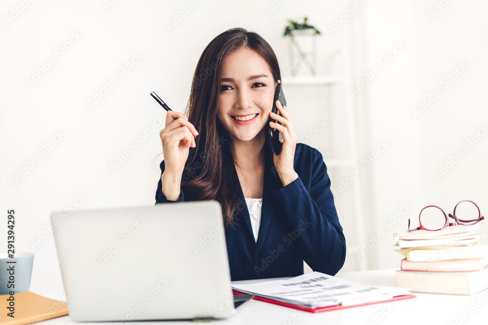 Businesswoman sitting and working with laptop computer.creative business people planning in her workstation at modern work loft Businesswoman sitting and working with laptop computer.creative business people planning in her workstation at modern work loft