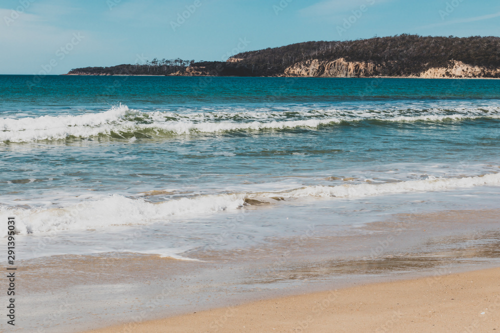 sunny pristine and deserted beach overlooking the South Pacific Ocean