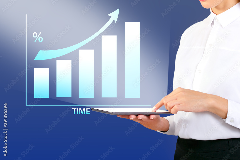 Woman With Tablet Pc At Office And Growth Chart. Businesswoman showing a growth chart. Woman With Tablet Pc At Office And Growth Chart. Businesswoman showing a growth chart.