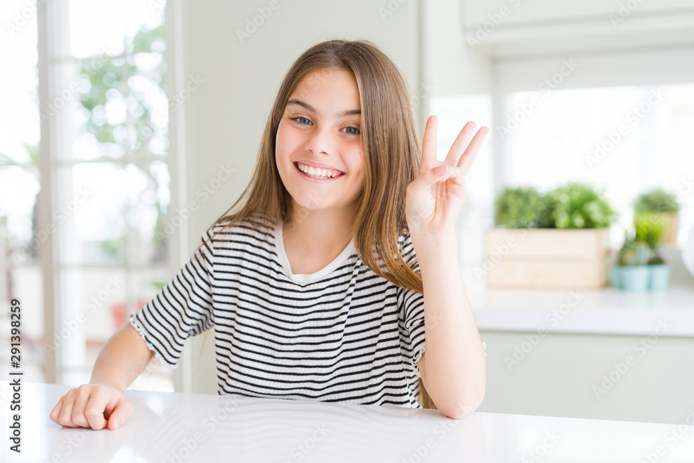 Beautiful young girl kid wearing stripes t-shirt showing and pointing up with fingers number three while smiling confident and happy. Beautiful young girl kid wearing stripes t-shirt showing and pointing up with fingers number three while smiling confident and happy.