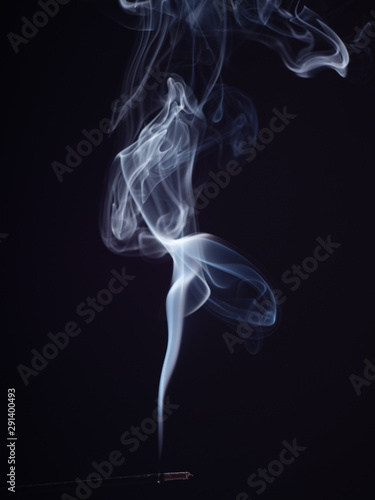 Abstract cloud of white smoke swirling on black background, close up view, isolated. Structure of white smoke, brush effect. Burning incense for meditation and relaxation, abstract background