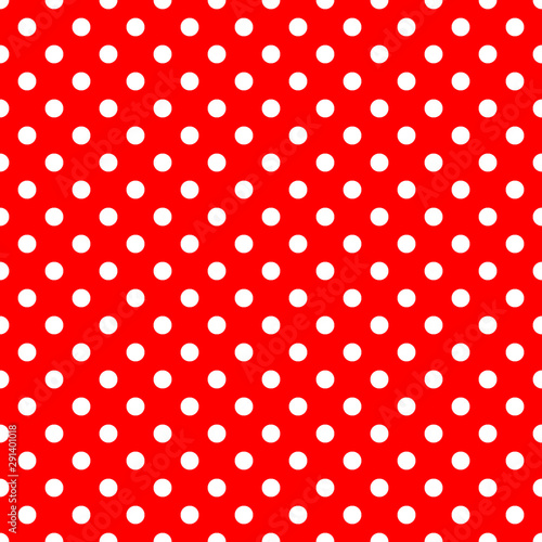 Seamless pattern with small polka dots. White polka dots on red background. Paper and fabric design and decor.