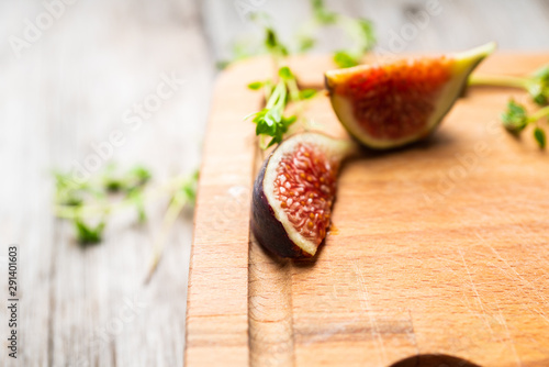 Figs slice on the wooden cutting board. Selective focus. Shallow depth of field.