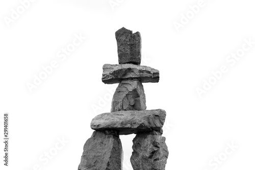 Inukshuk isolated on white background. Human-made stone landmark.