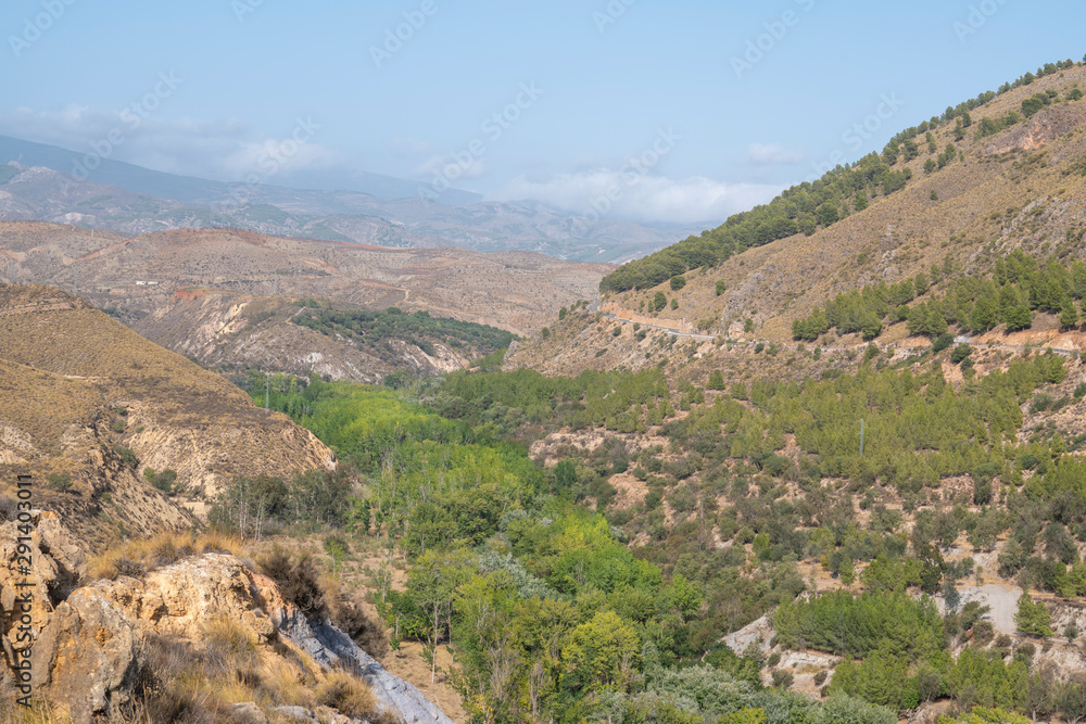 Panoramic view of the Lucainena River with its green leafy trees. Panoramic view of the Lucainena River with its green leafy trees.