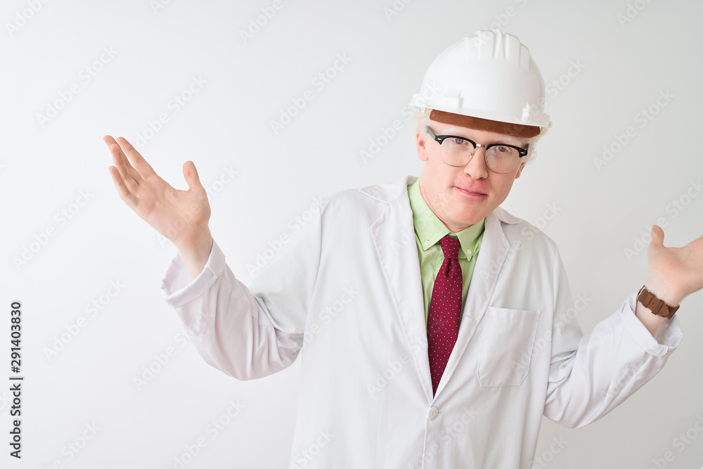 Albino scientist man wearing glasses and helmet standing over isolated white background clueless and confused expression with arms and hands raised. Doubt concept. Albino scientist man wearing glasses and helmet standing over isolated white background clueless and confused expression with arms and hands raised. Doubt concept.
