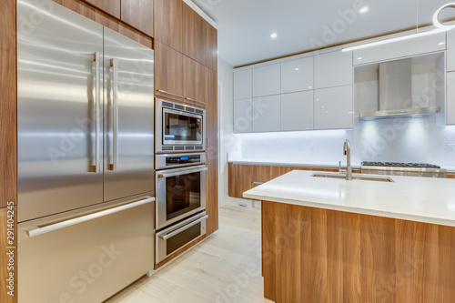 Interior design of a modern kitchen in the newly built house  with stainless steel appliances.