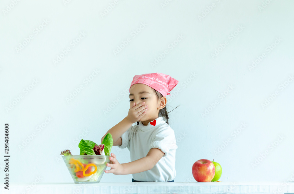 Little girl do not eat vegetable with isolated on white(health concept) Little girl do not eat vegetable with isolated on white(health concept)