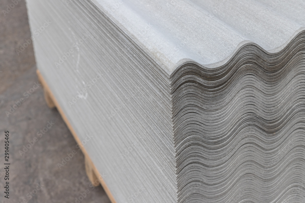 Many gray slate sheets are stacked on top of each other. Wavy stripes pattern Many gray slate sheets are stacked on top of each other. Wavy stripes pattern
