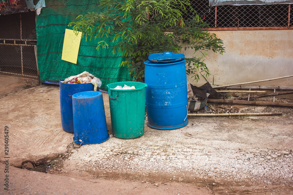 Four plastic recycling bins on the street Four plastic recycling bins on the street