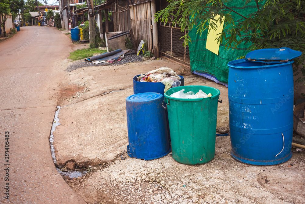 Four plastic recycling bins on the street Four plastic recycling bins on the street