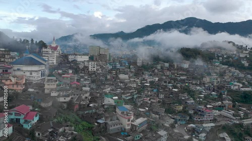 4k Aerial Panning shot of Kohima city covered in Fog, Nagaland, India. The capital city of Nagaland, famous for the Horn Bill Festival and the tribes photo